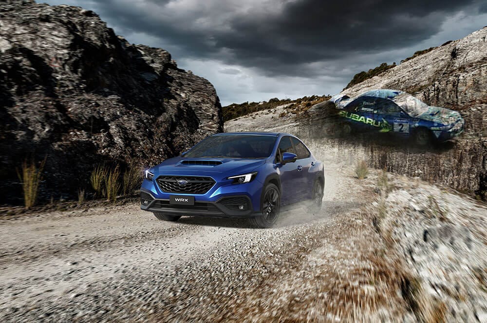 Blue Subaru WRX in dynamic off-road action, showcasing AWD capabilities